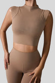 StudioLine High-Neck Tank in camel, front view showing cropped fit and high neckline
