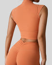 StudioLine High-Neck Tank in caramel, back view showing minimalist cropped silhouette