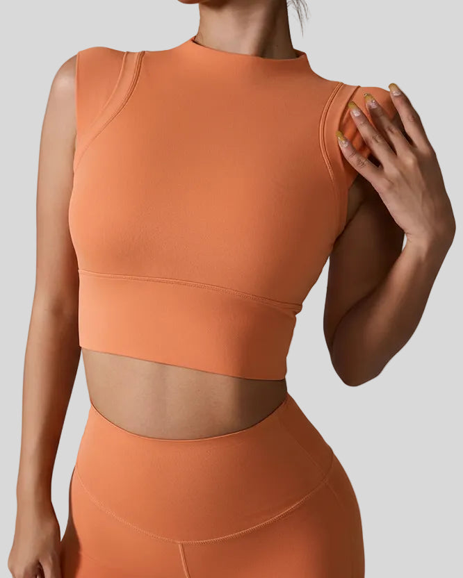 StudioLine High-Neck Tank caramel, angled view highlighting clean arm openings and smooth fabric