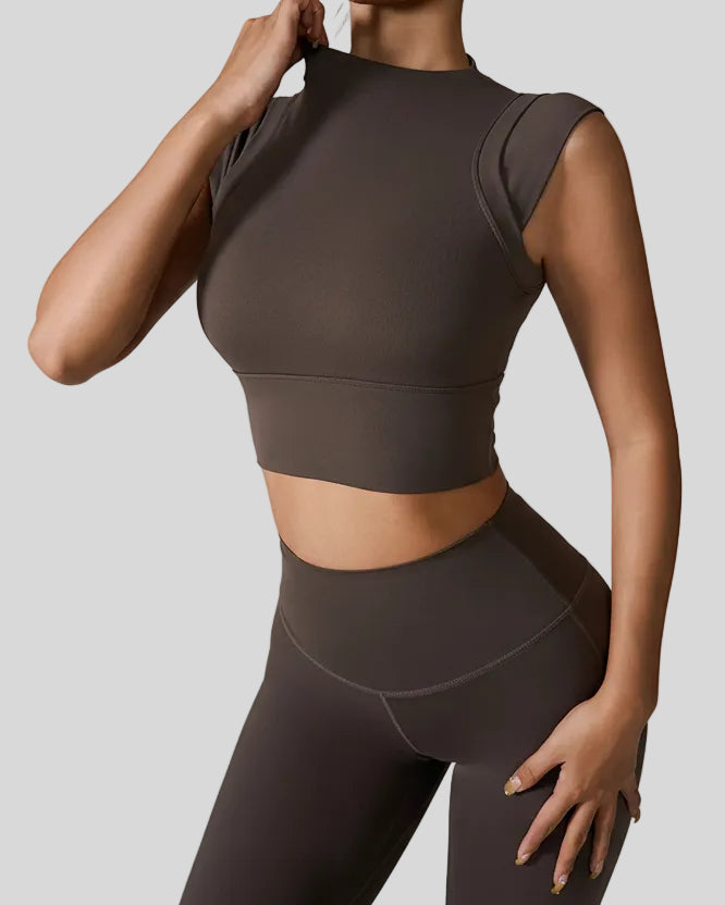 StudioLine High-Neck Tank mocha, angled view highlighting clean arm openings and smooth fabric