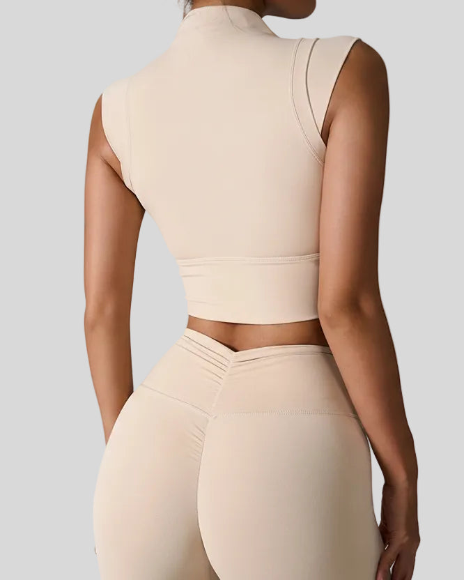 StudioLine High-Neck Tank in tan, back view showing minimalist cropped silhouette