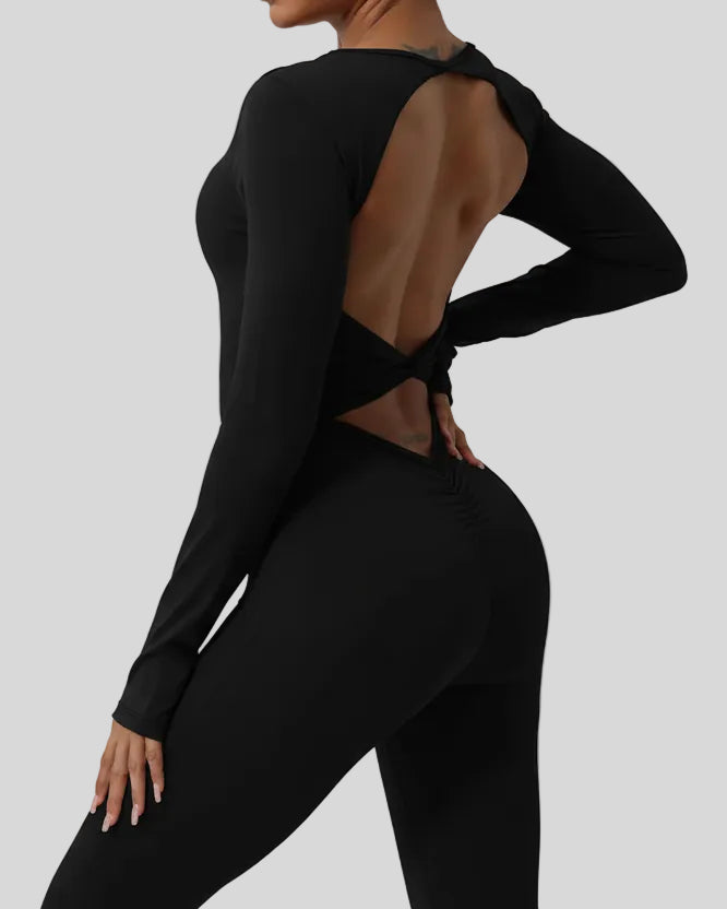 Close-up of twisted open-back detail on StudioTwist jumpsuit in black