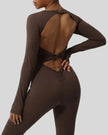 Close-up of twisted open-back detail on StudioTwist jumpsuit in chocolate
