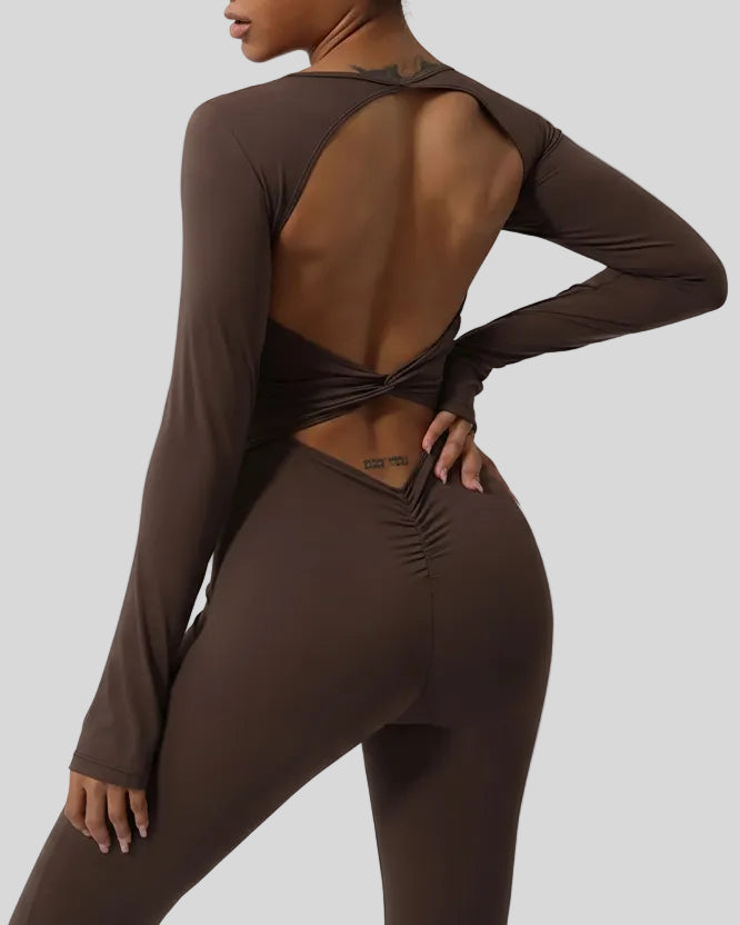 Close-up of twisted open-back detail on StudioTwist jumpsuit in chocolate