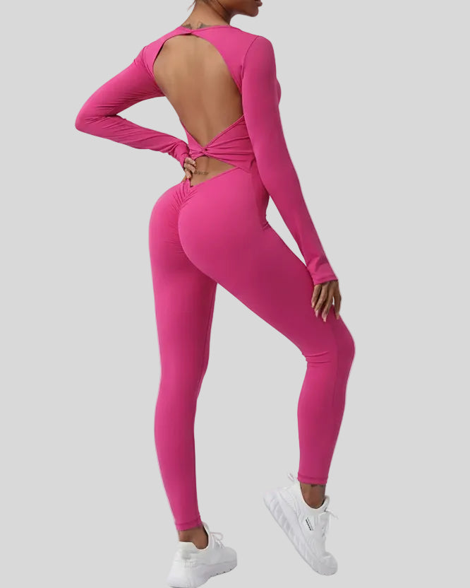 StudioTwist open-back jumpsuit in hot pink showing twisted back design