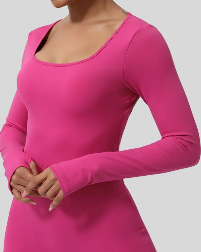 Close-up of Athlesi StudioTwist Open  Back Jumpsuit fabric and waistline detail in hot pink