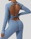 Close-up of twisted open-back detail on StudioTwist jumpsuit in light blue