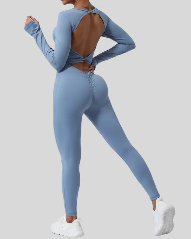 StudioTwist open-back jumpsuit in light blue showing twisted back design