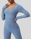 Close-up of Athlesi StudioTwist Open  Back Jumpsuit fabric and waistline detail in light blue