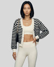 Front angle view of black striped cropped cardigan with cozy balloon sleeves