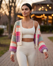 Lifestyle view of multicolor cropped cardigan layered over activewear for elevated casual styling
