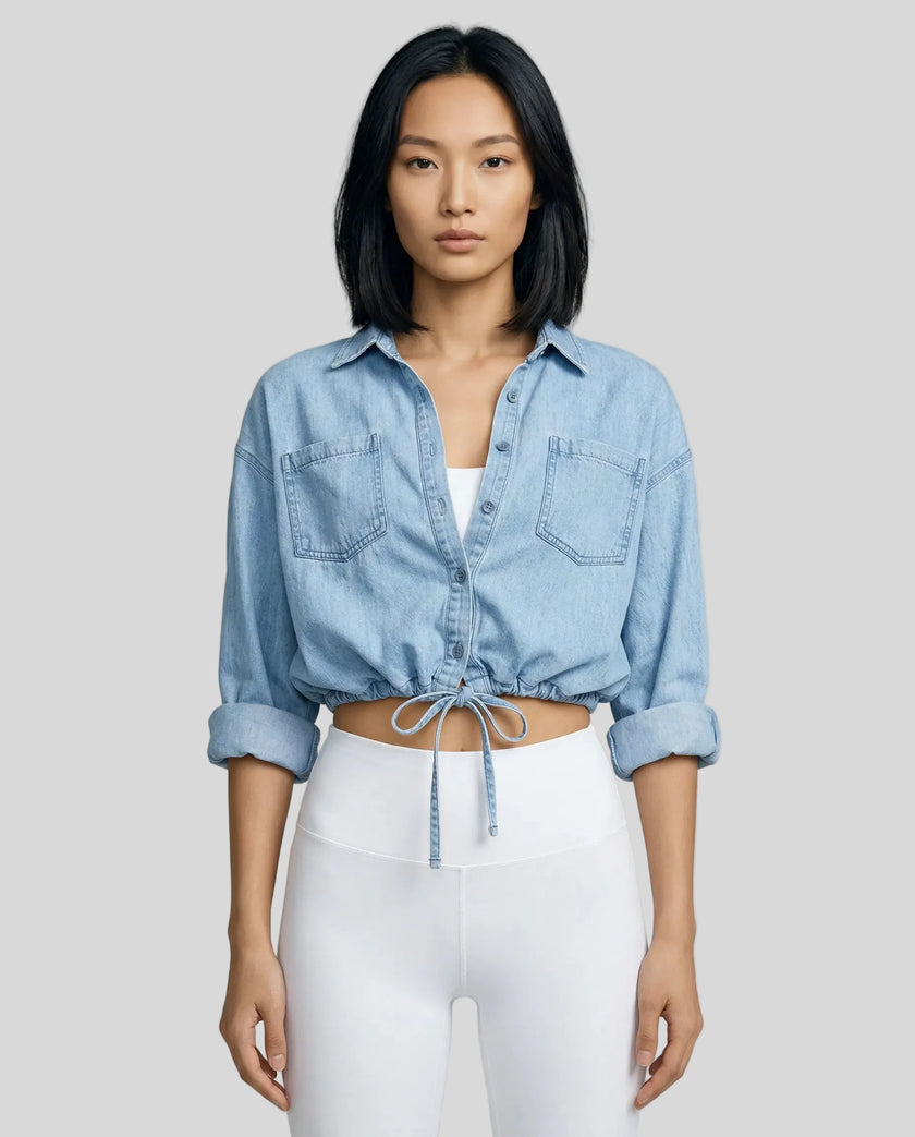 Model wearing light blue TieForm Denim Top styled with neutral bottoms showing adjustable tie waist fit