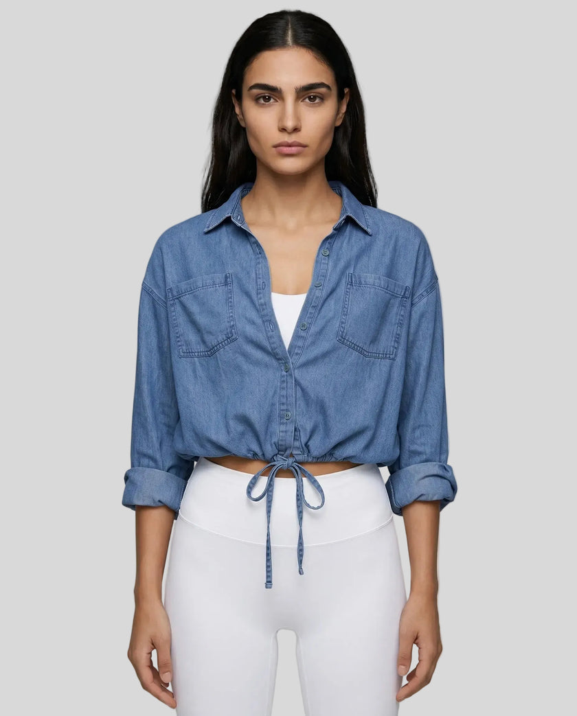 Model wearing medium blue TieForm Denim Top styled with neutral bottoms showing adjustable tie waist fit
