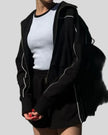 Close-up of Athlesi black TrackEase jacket with contrast piping detail