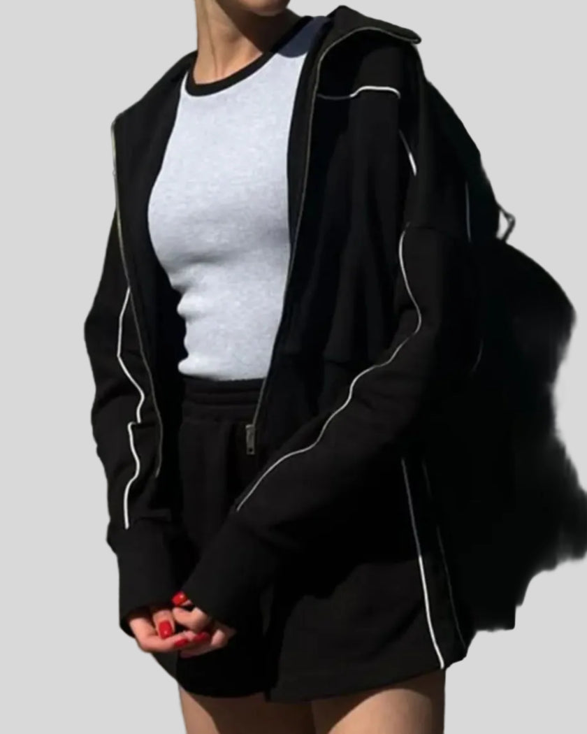 Close-up of Athlesi black TrackEase jacket with contrast piping detail
