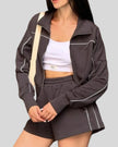 Close-up of Athlesi brown TrackEase jacket with contrast piping detail