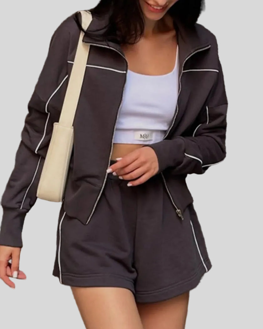 Mid body view of Athlesi brown TrackEase jacket and shorts set