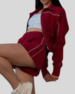 Side view of Athlesi burgundy TrackEase jacket and shorts set