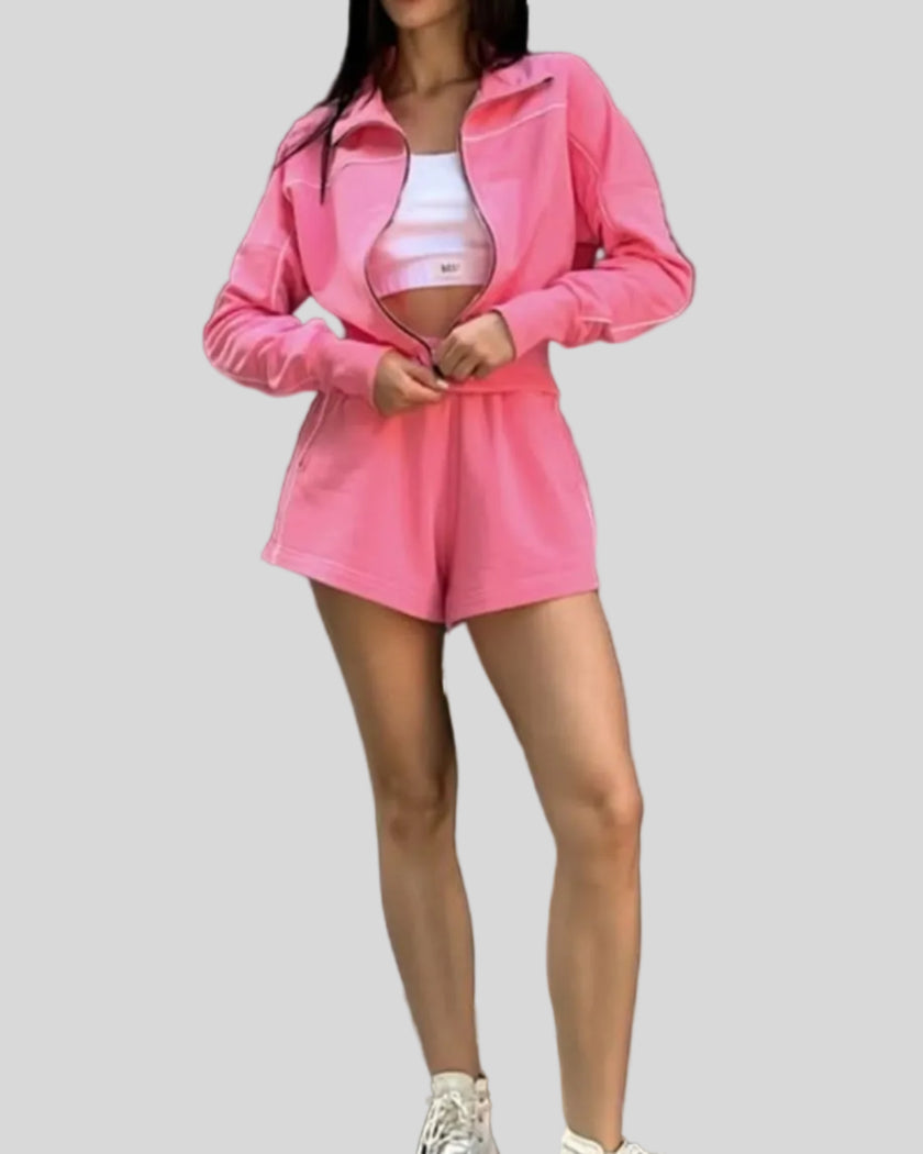 Model wearing Athlesi TrackEase jacket and shorts set in hot pink front full body