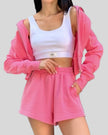 Mid body view of Athlesi hot pink TrackEase jacket and shorts set