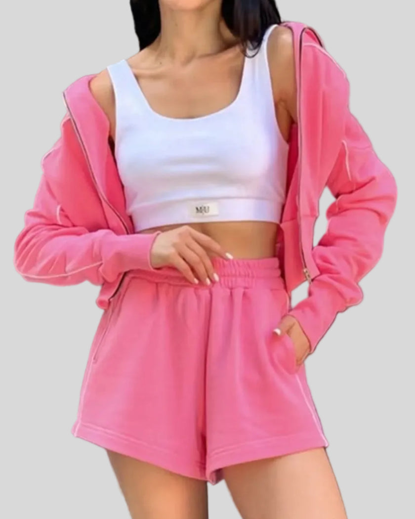 Mid body view of Athlesi hot pink TrackEase jacket and shorts set
