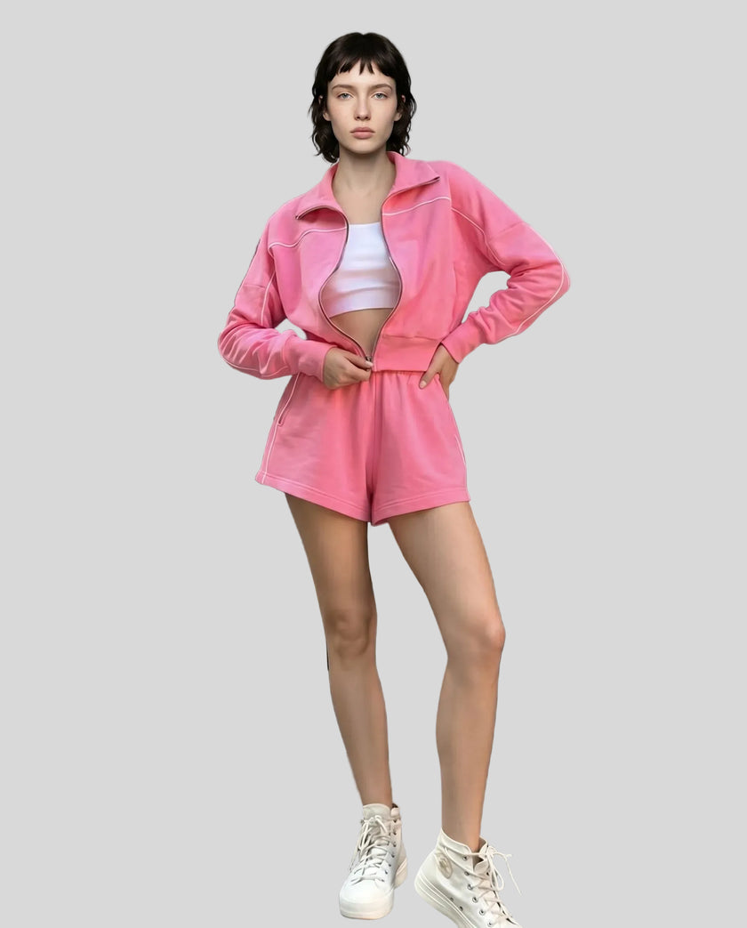 Model standing wearing Athlesi hot pink TrackEase jacket and shorts set