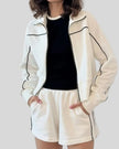 Mid body view of Athlesi ivory TrackEase jacket and shorts set