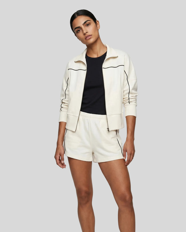 Model wearing Athlesi ivory TrackEase jacket and shorts set full body front
