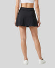 Lower body back view of a woman wearing the Athlesi TrackLine A-Line Skirt in black