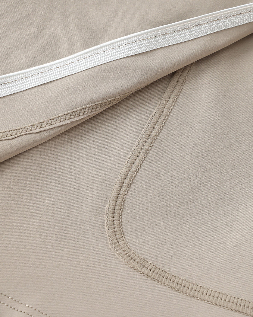 Closeup of the stretch performance fabric on the Athlesi TrackLine A-Line Skirt in light coffee