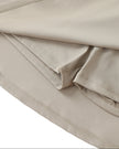 Hem detail closeup of the Athlesi TrackLine A-Line Skirt in light coffee