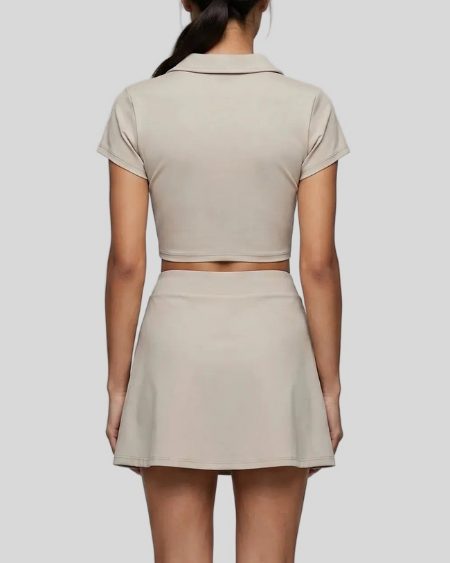 Mid body back view of the Athlesi TrackLine A-Line Skirt in light coffee styled with the matching TrackLine Lapel Crop Top