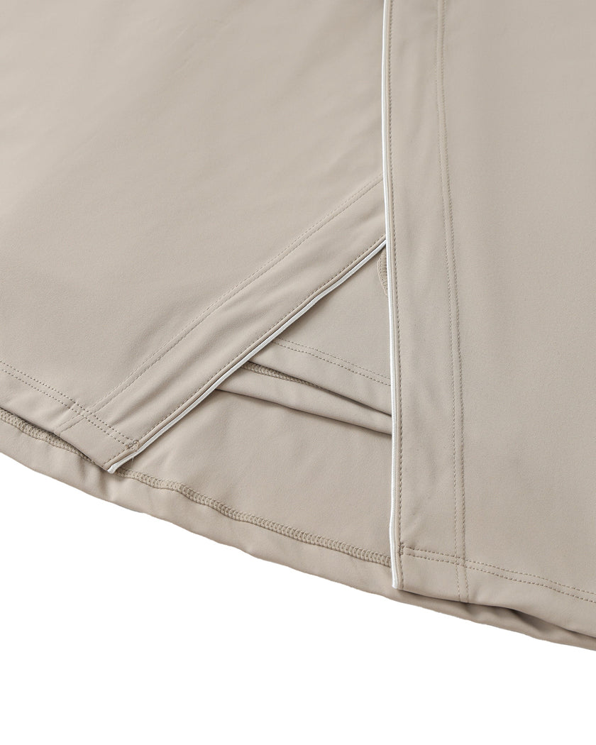 Wrap slit detail closeup of the Athlesi TrackLine A-Line Skirt in light coffee