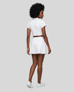 Full body back view of the Athlesi TrackLine A-Line Skirt in white styled with the matching TrackLine Lapel Crop Top