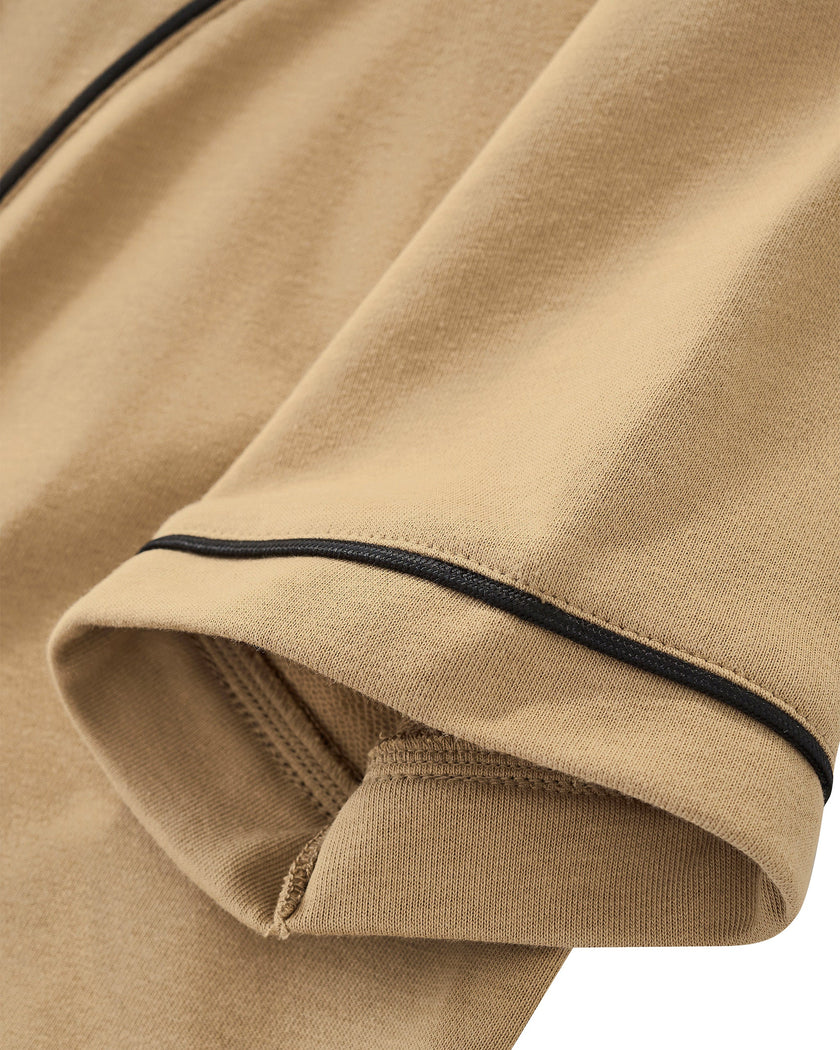 Sleeve close-up of TrackLine Baseball Jersey in Coffee showing contrast piping along the short sleeve hem