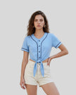 Woman wearing the TrackLine Baseball Jersey in Sky Blue tied at the front with a cropped casual fit