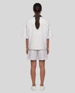 Model wearing the Athlesi TrackLine Baseball Striped Jersey in white, back view