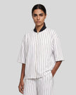 Model wearing the Athlesi TrackLine Baseball Striped Jersey in white from a front angle
