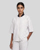 Model wearing the Athlesi TrackLine Baseball Striped Jersey in white from a front angle