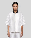 Model wearing the Athlesi TrackLine Baseball Striped Jersey in white, front view