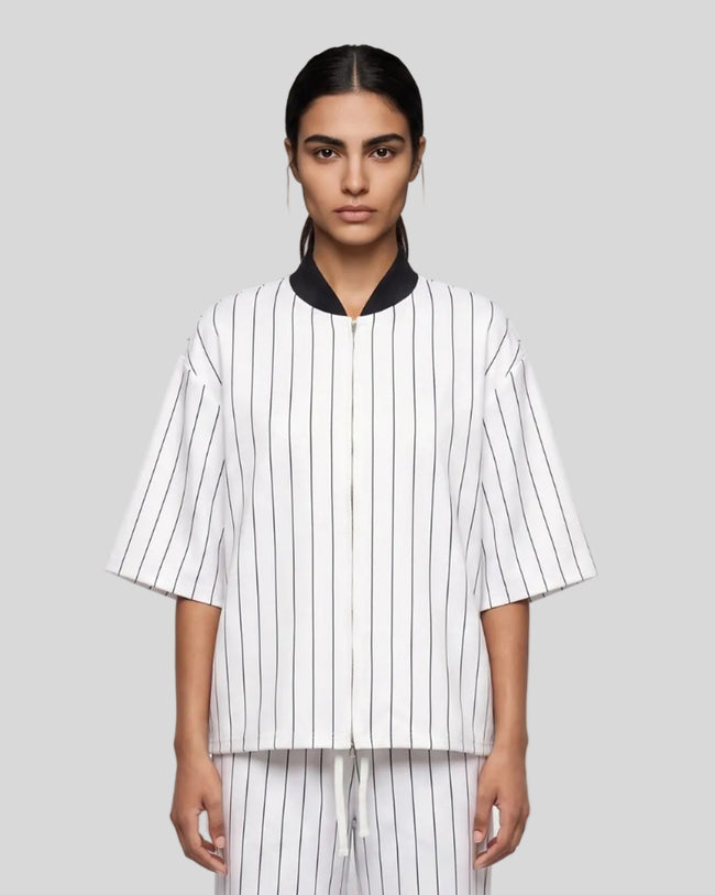 Model wearing the Athlesi TrackLine Baseball Striped Jersey in white, front view