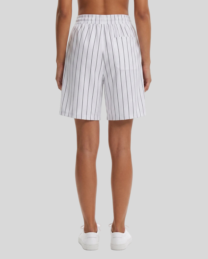 Model wearing the Athlesi TrackLine Baseball Striped Shorts in white, back view