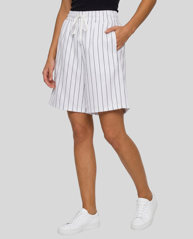 Model wearing the Athlesi TrackLine Baseball Striped Shorts in white from a front angle