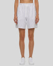 Model wearing the Athlesi TrackLine Baseball Striped Shorts in white, front view
