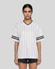 Woman wearing the TrackLine Baseball Striped Tee in White from the front showing its relaxed unisex fit and retro athletic styling.