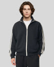 Model wearing TrackLine Club Jacket in Black semi-zipped front view