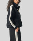 Woman Model wearing TrackLine Club Jacket in Khaki side view