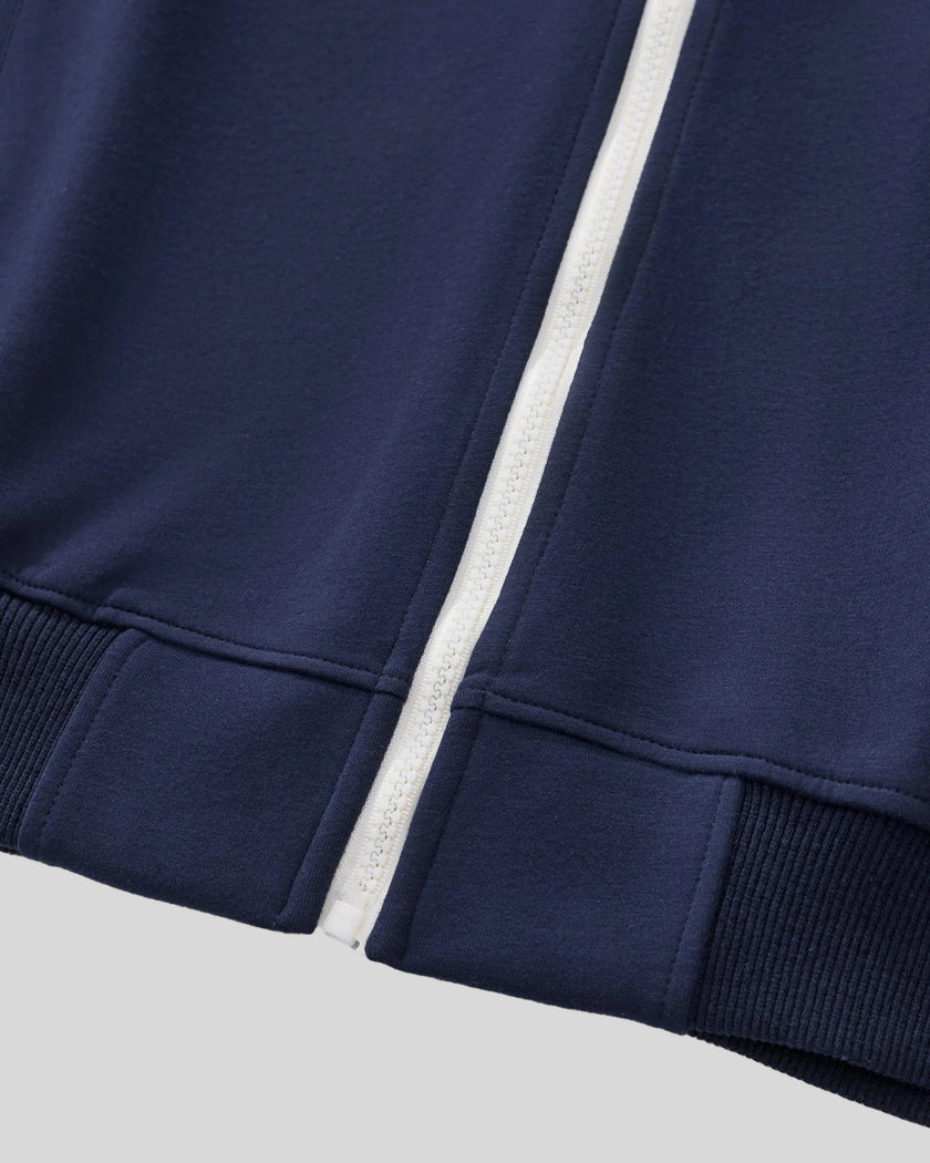 Front zipper and ribbed hem detail of TrackLine Club Jacket in Royal Blue