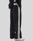 Model wearing TrackLine Club Pants in Black angled back view