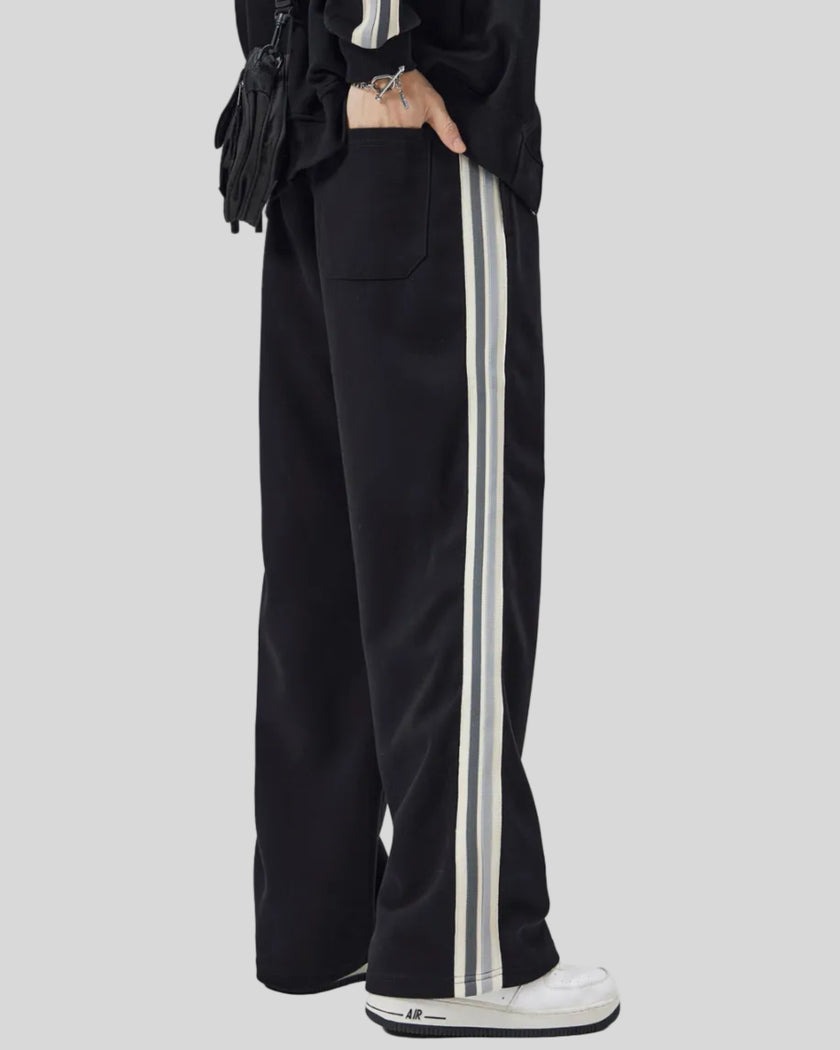 Model wearing TrackLine Club Pants in Black angled back view